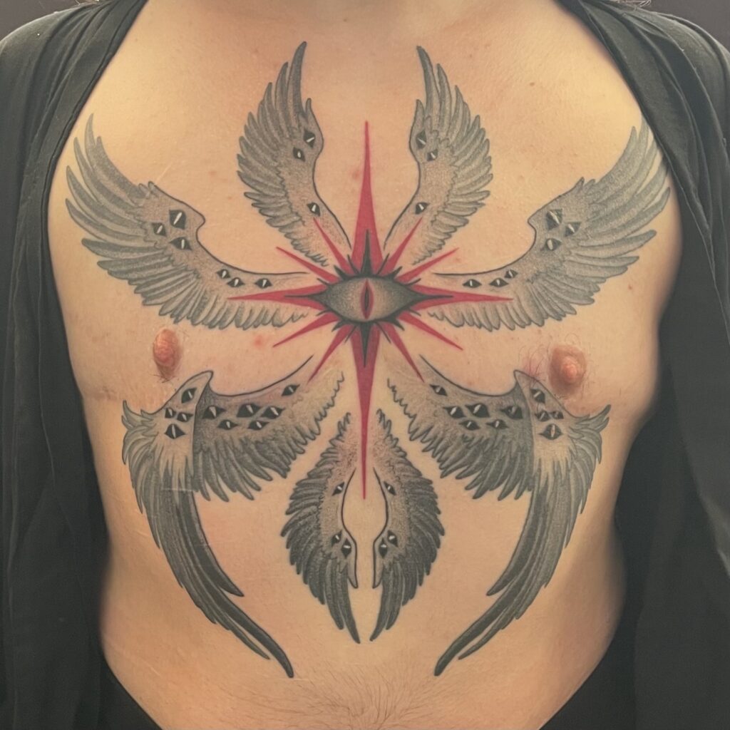 a tattoo of a seraphim with many wings and too many eyes on the chest. The shading is all black and grey dot shading, except for the red star in the middle, surrounding the eye. 